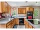 Bright kitchen featuring wood cabinetry, stainless steel appliances, and ample counter space with a modern cooktop at 1611 County Road 753S, Webster, FL 33597