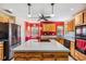 Spacious kitchen with an island, wood cabinetry, and modern appliances for convenient meal preparation at 1611 County Road 753S, Webster, FL 33597