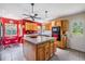 Bright kitchen with red walls, a kitchen island and modern appliances, perfect for culinary enthusiasts at 1611 County Road 753S, Webster, FL 33597