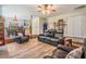 Spacious living room with wood floors and comfortable seating, adjacent to the dining area at 1611 County Road 753S, Webster, FL 33597