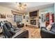 Inviting living room with a stone fireplace, ceiling fan, and comfortable seating for entertainment at 1611 County Road 753S, Webster, FL 33597