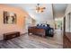 Spacious main bedroom showcasing wood flooring, with a cozy window seat and ample natural light at 1611 County Road 753S, Webster, FL 33597