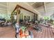 Inviting covered porch features comfortable seating, a grill, and a cozy fire pit at 1611 County Road 753S, Webster, FL 33597