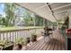 Charming covered porch with ample seating and decorative potted plants at 1611 County Road 753S, Webster, FL 33597