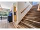 Tiled stairway with wooden railing ascending to the upper level of the home at 1611 County Road 753S, Webster, FL 33597