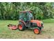Exterior view of the newer model Kubota tractor with mower attachment on green lawn at 1611 County Road 753S, Webster, FL 33597