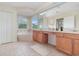 Primary bathroom with double sink vanity, garden tub, and bright window at 239 Beacon Pointe Dr, Ocoee, FL 34761