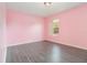 Bright bedroom featuring wood-look floors and a view to the outdoors at 239 Beacon Pointe Dr, Ocoee, FL 34761