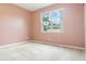 Neutral bedroom with a large window offering natural light, enhancing the room's cozy ambiance at 239 Beacon Pointe Dr, Ocoee, FL 34761