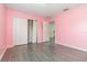 Bedroom with view of walk-in closet and hallway, painted in a calming pink hue at 239 Beacon Pointe Dr, Ocoee, FL 34761