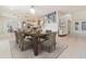 Inviting dining room with a dark wood table, gray chairs, and view of the stairwell at 239 Beacon Pointe Dr, Ocoee, FL 34761