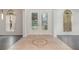 Elegant entryway features decorative tiled floor and glass paneled front door at 239 Beacon Pointe Dr, Ocoee, FL 34761