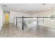Upstairs hallway with wood flooring and a white and black staircase at 239 Beacon Pointe Dr, Ocoee, FL 34761