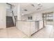 Open kitchen featuring an island with seating, tile flooring, and stainless steel appliances at 239 Beacon Pointe Dr, Ocoee, FL 34761