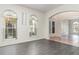 Inviting living room with wood floors, arched windows and entry, and neutral color palette at 239 Beacon Pointe Dr, Ocoee, FL 34761