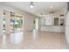 Expansive living area with tile flooring, sliding glass doors, and bar seating at 239 Beacon Pointe Dr, Ocoee, FL 34761