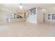 Open-concept living room with tile flooring and view of the kitchen and staircase at 239 Beacon Pointe Dr, Ocoee, FL 34761