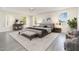 Relaxing main bedroom with a tray ceiling, bench, and area rug at 239 Beacon Pointe Dr, Ocoee, FL 34761