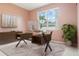 Bright office space features a stylish glass desk, modern decor, and a large window with a view at 239 Beacon Pointe Dr, Ocoee, FL 34761