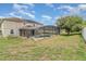 Features a large screened pool and backyard with dry grass at 239 Beacon Pointe Dr, Ocoee, FL 34761