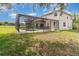 Backyard view featuring a screened-in pool and a stucco home exterior at 239 Beacon Pointe Dr, Ocoee, FL 34761