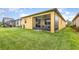 Backyard with an outdoor patio area with furniture and a screened-in porch at 472 Pontevedra Rd, Davenport, FL 33837