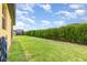Expansive backyard with lush lawn and a neatly trimmed hedge, perfect for outdoor activities at 472 Pontevedra Rd, Davenport, FL 33837
