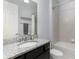Bright bathroom with granite countertop, dark wood cabinets, shower and tub combo at 472 Pontevedra Rd, Davenport, FL 33837