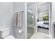 Bathroom featuring a walk-in shower with glass door and chrome fixtures, and a toilet with storage space at 472 Pontevedra Rd, Davenport, FL 33837