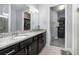 Bathroom featuring a double vanity with granite countertops, and a walk-in closet for ample storage space at 472 Pontevedra Rd, Davenport, FL 33837