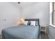 Cozy bedroom features a comfortable bed with a gray headboard and stylish blue patterned quilt at 472 Pontevedra Rd, Davenport, FL 33837