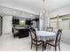 Bright dining area adjacent to a modern kitchen, perfect for Gathering meals at 472 Pontevedra Rd, Davenport, FL 33837