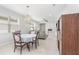Elegant dining area with a chandelier, seamlessly connected to the living room at 472 Pontevedra Rd, Davenport, FL 33837