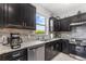 Well-equipped kitchen with stainless steel appliances, granite countertops, and dark cabinets providing ample storage at 472 Pontevedra Rd, Davenport, FL 33837