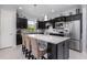 Spacious kitchen boasts dark cabinets, stainless steel appliances, and a large center island with bar seating at 472 Pontevedra Rd, Davenport, FL 33837