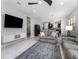 Spacious living room featuring modern decor, an entertainment center, and natural light at 472 Pontevedra Rd, Davenport, FL 33837