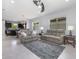 Open-concept living room with neutral tones, tile flooring, and a ceiling fan at 472 Pontevedra Rd, Davenport, FL 33837