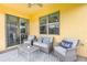 Relaxing outdoor patio seating with ceiling fan and sliding door access to the indoors at 472 Pontevedra Rd, Davenport, FL 33837