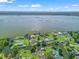 Expansive aerial view showcasing canal-front homes, waterfront living, and serene lake scenery at 718 Cr 467, Lake Panasoffkee, FL 33538