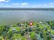 Wide aerial view of the waterfront neighborhood community with nearby lake in the distance at 718 Cr 467, Lake Panasoffkee, FL 33538