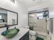 Bathroom featuring a vessel sink, walk-in shower with glass doors, and tiled walls and flooring at 718 Cr 467, Lake Panasoffkee, FL 33538