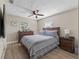 Comfortable bedroom with wood-look floors, ceiling fan, and dresser at 718 Cr 467, Lake Panasoffkee, FL 33538