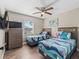 Bright bedroom featuring two twin beds, wood-look flooring, and a ceiling fan at 718 Cr 467, Lake Panasoffkee, FL 33538