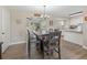 Bright dining area with modern table set, open to the kitchen, complemented by stylish lighting at 718 Cr 467, Lake Panasoffkee, FL 33538