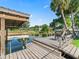 Private wooden boat dock with covered area, space for seating, and access to the canal at 718 Cr 467, Lake Panasoffkee, FL 33538