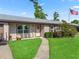 Inviting home exterior with a lush lawn, walkway, and an American flag, offering classic charm at 718 Cr 467, Lake Panasoffkee, FL 33538