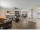 Spacious open-concept living room and dining area, featuring modern flooring and plenty of natural light at 718 Cr 467, Lake Panasoffkee, FL 33538