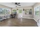 Bright office with a computer desk, ceiling fan, wood-look floors, and many windows at 718 Cr 467, Lake Panasoffkee, FL 33538