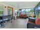 Covered patio with outdoor seating and barbecue grill, perfect for entertaining at 718 Cr 467, Lake Panasoffkee, FL 33538