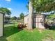 Storage shed in backyard has double doors, lawn mower, yard tools, and gated fence at 718 Cr 467, Lake Panasoffkee, FL 33538